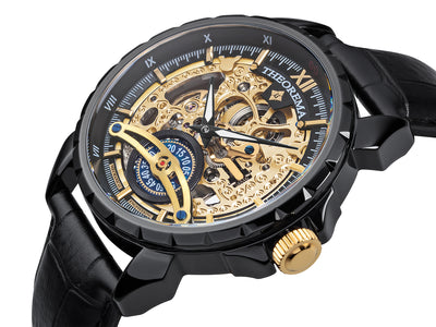 Engraved gold color dial with Roman numerals on the black bezel. An engraved circled crown.