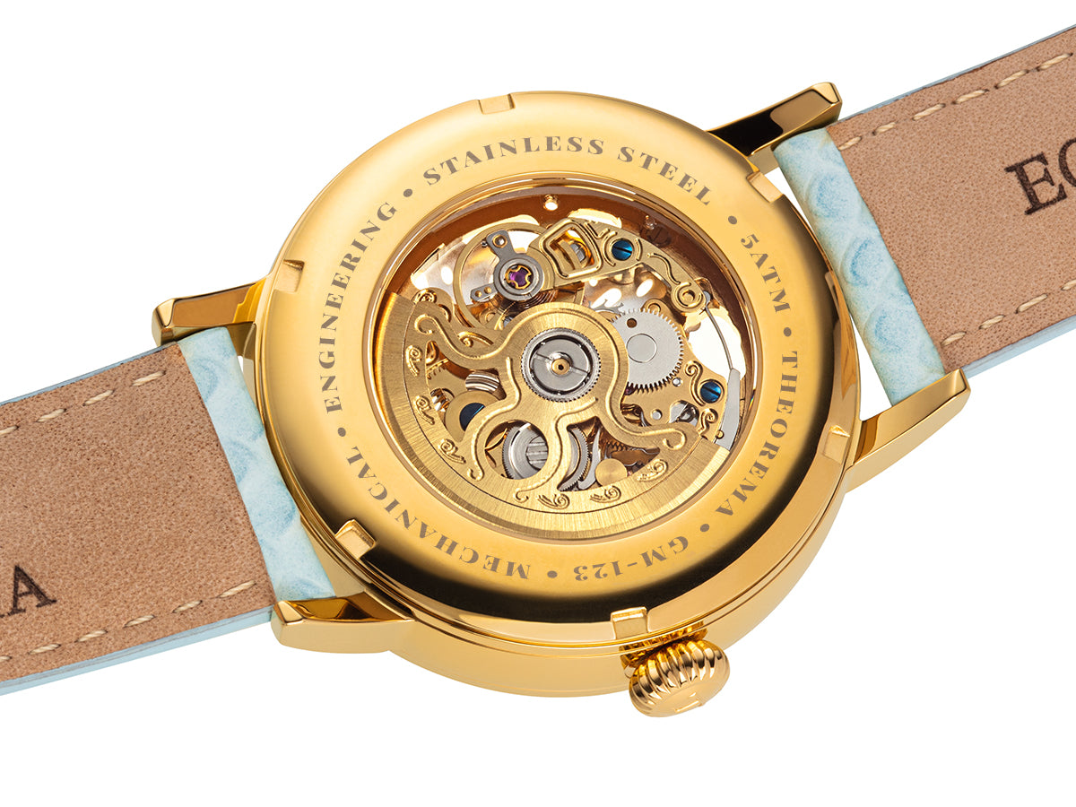 Gold color movement open back to see the inside of the mechanism and gears. 
